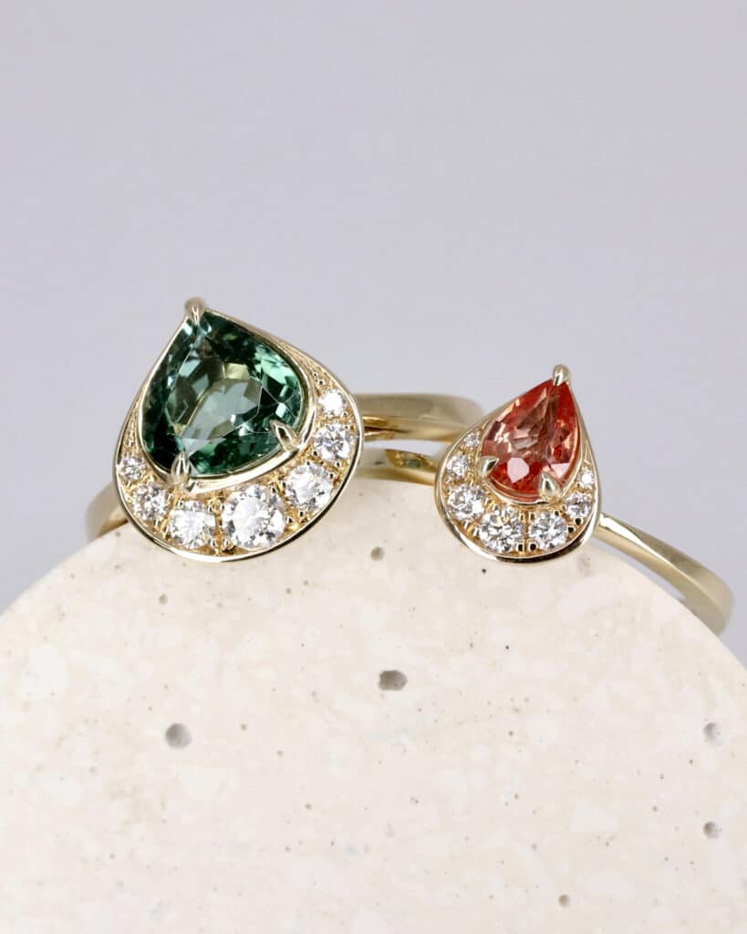 ‘Crescent’ collection rings. Seagreen tourmaline and peach sapphire with white diamond crescent moon half halos